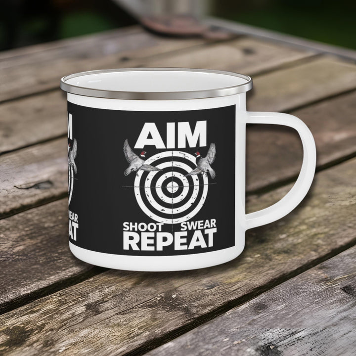 Enamel mug with “Aim Shoot Swear Repeat” design featuring a target and flying ducks.